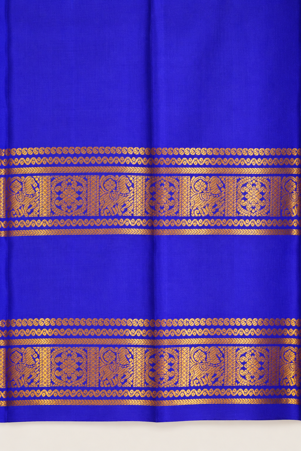 A luxurious royal violet Kanjivaram silk saree paired with a peacock teal pallu