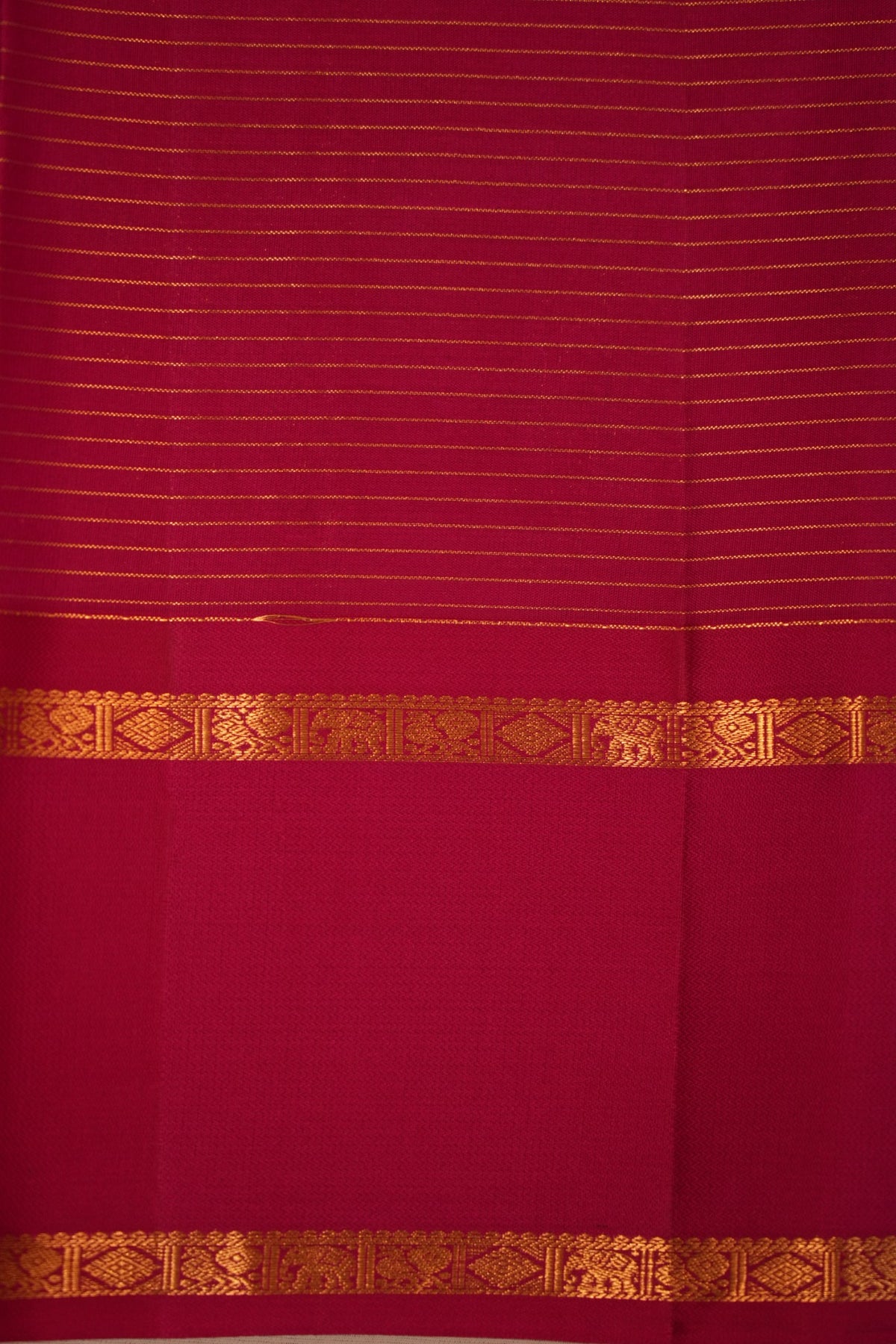 Vibrant turquoise blue Kanjivaram silk with gold zari checks and leaf motifs, complemented by magenta and a traditional elephant, peacock & diamond zari border.