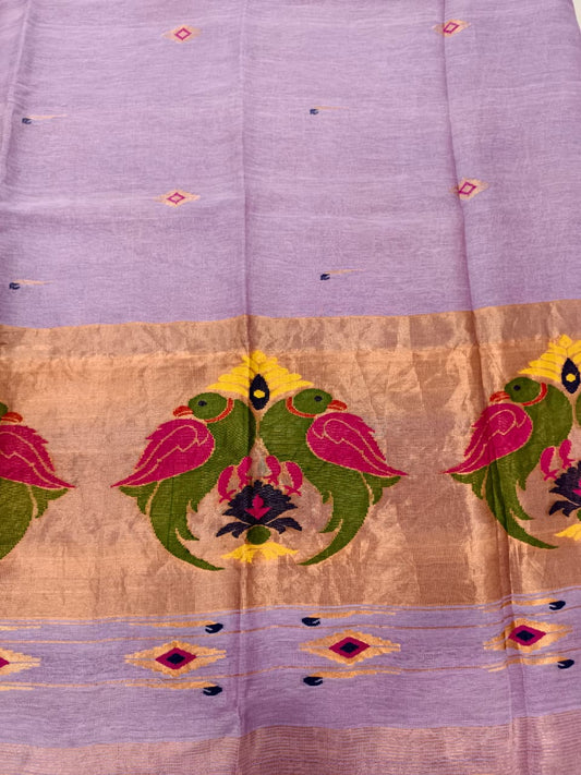 Elegant lavender Tissue Linen Jamdani saree with Paithani-style handwoven parrot motifs and delicate golden zari detailing.