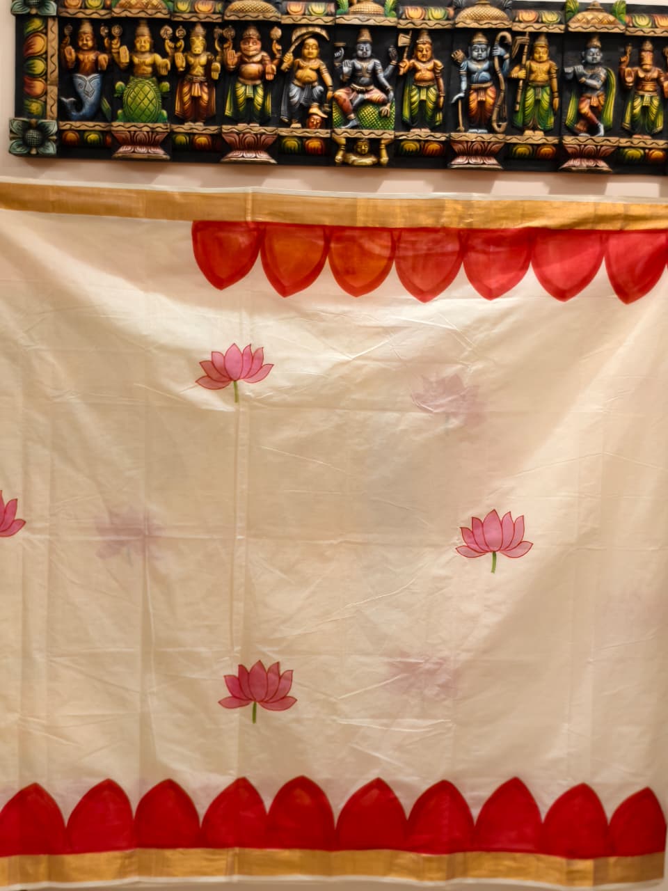 A beautiful hand-painted Durga Parivar design on a cotton saree with contrasting yellow blouse piece
