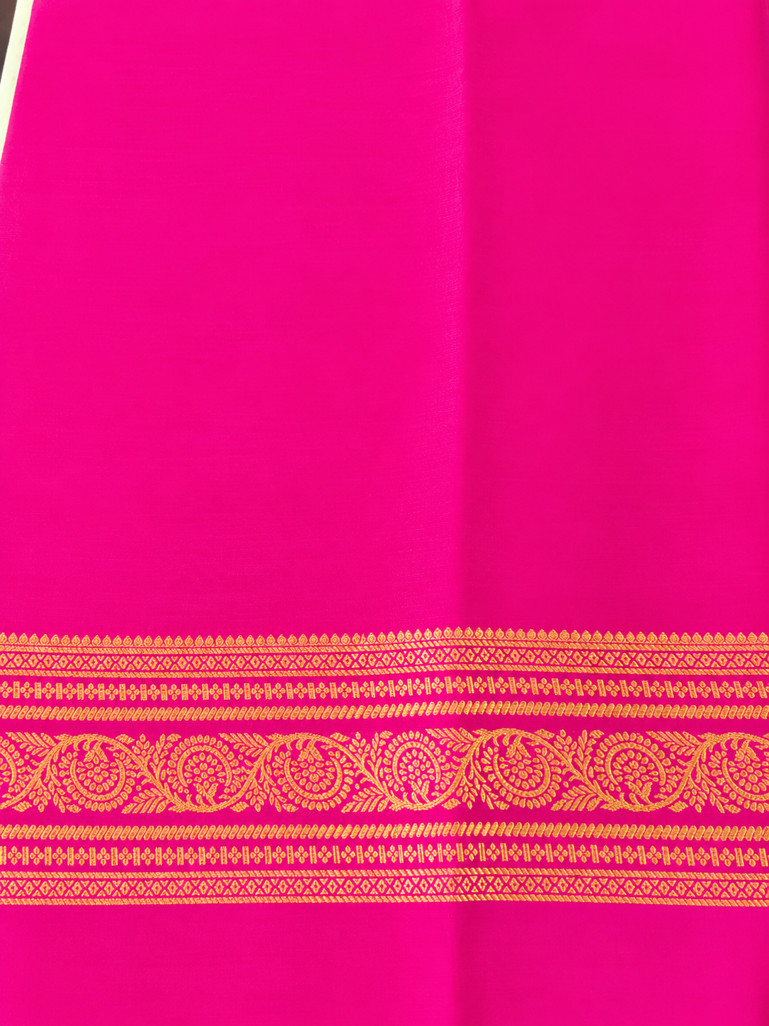 legant pastel green Pure Mysore Silk Crepe with a vibrant Rani Pink pallu and intricate floral gold zari borders.