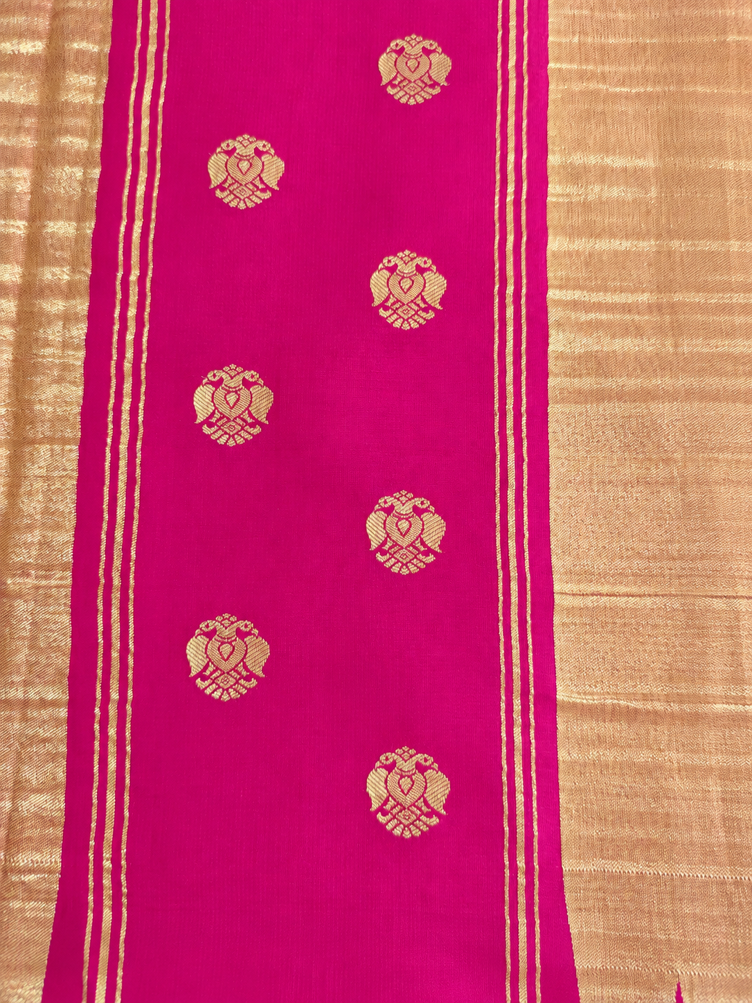 Rich magenta Mysore Crepe silk adorned throughout with Peacock, Gandaberunda, Topi and Elephant motifs in exquisite gold zari.