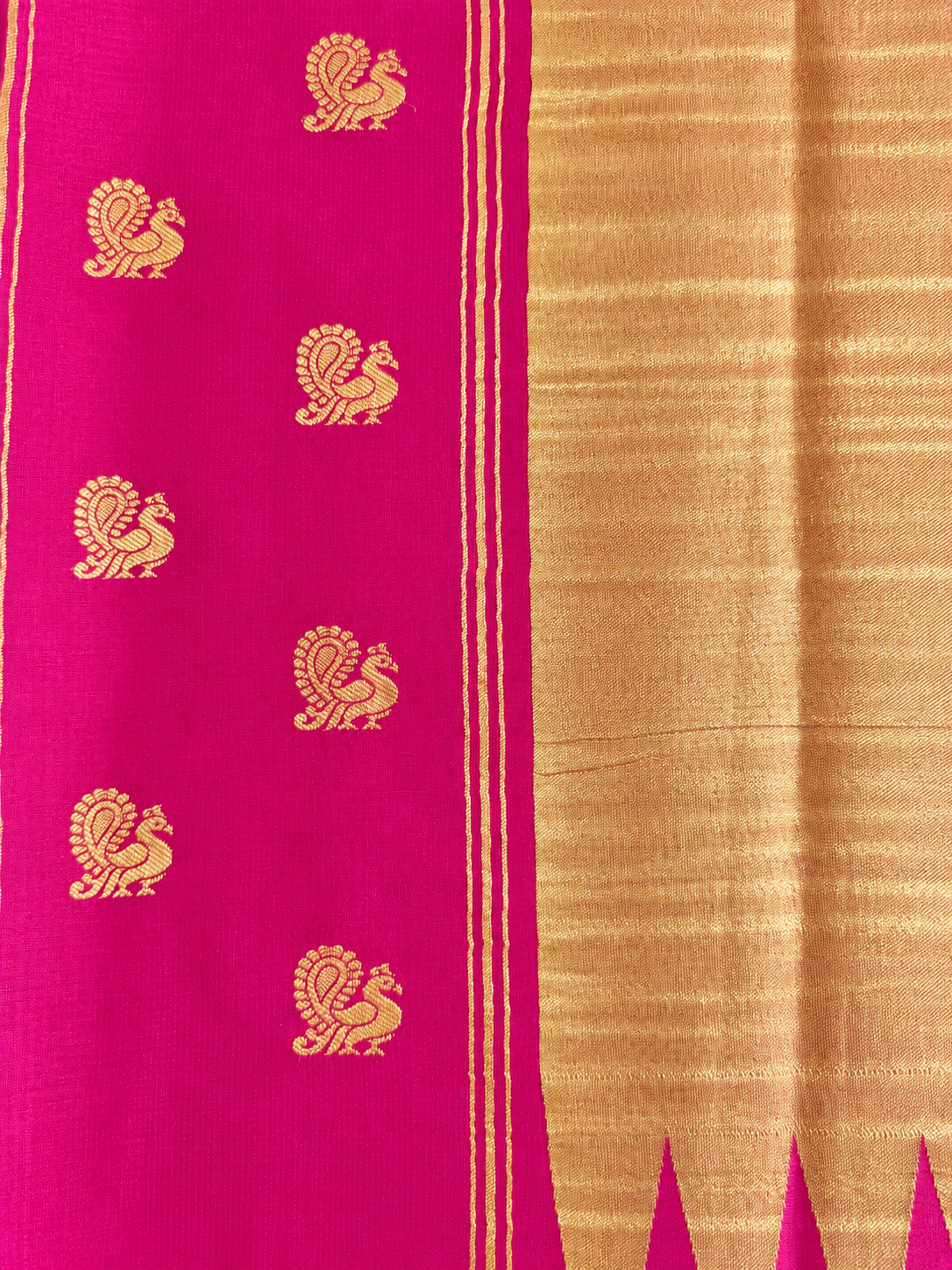 Rich magenta Mysore Crepe silk adorned throughout with Peacock, Gandaberunda, Topi and Elephant motifs in exquisite gold zari.