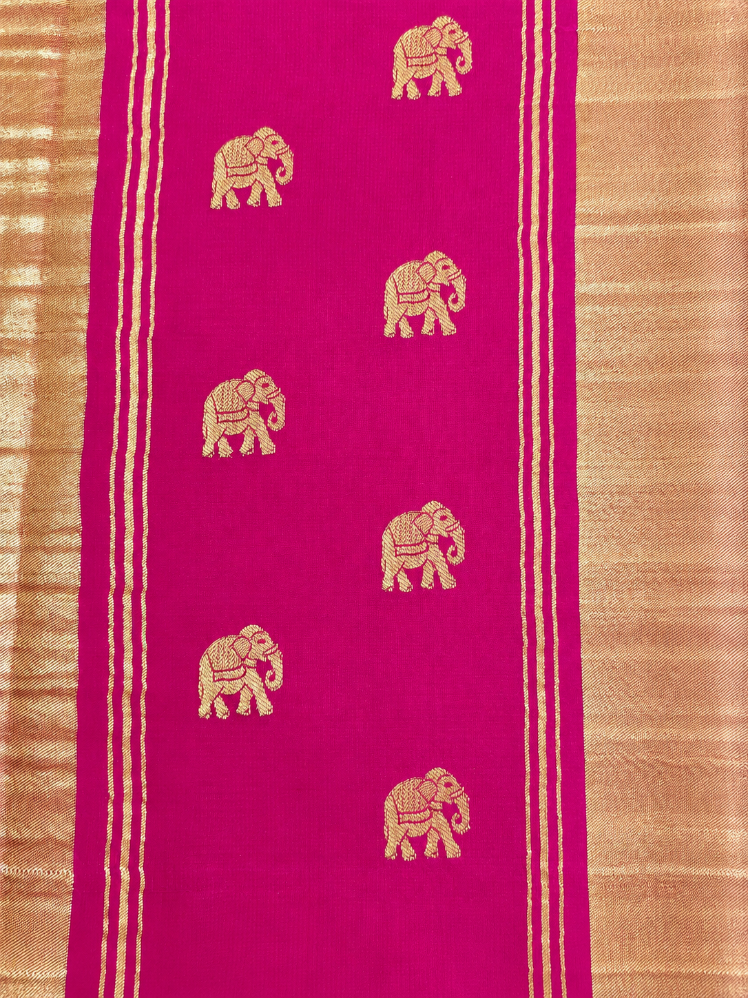 Rich magenta Mysore Crepe silk adorned throughout with Peacock, Gandaberunda, Topi and Elephant motifs in exquisite gold zari.