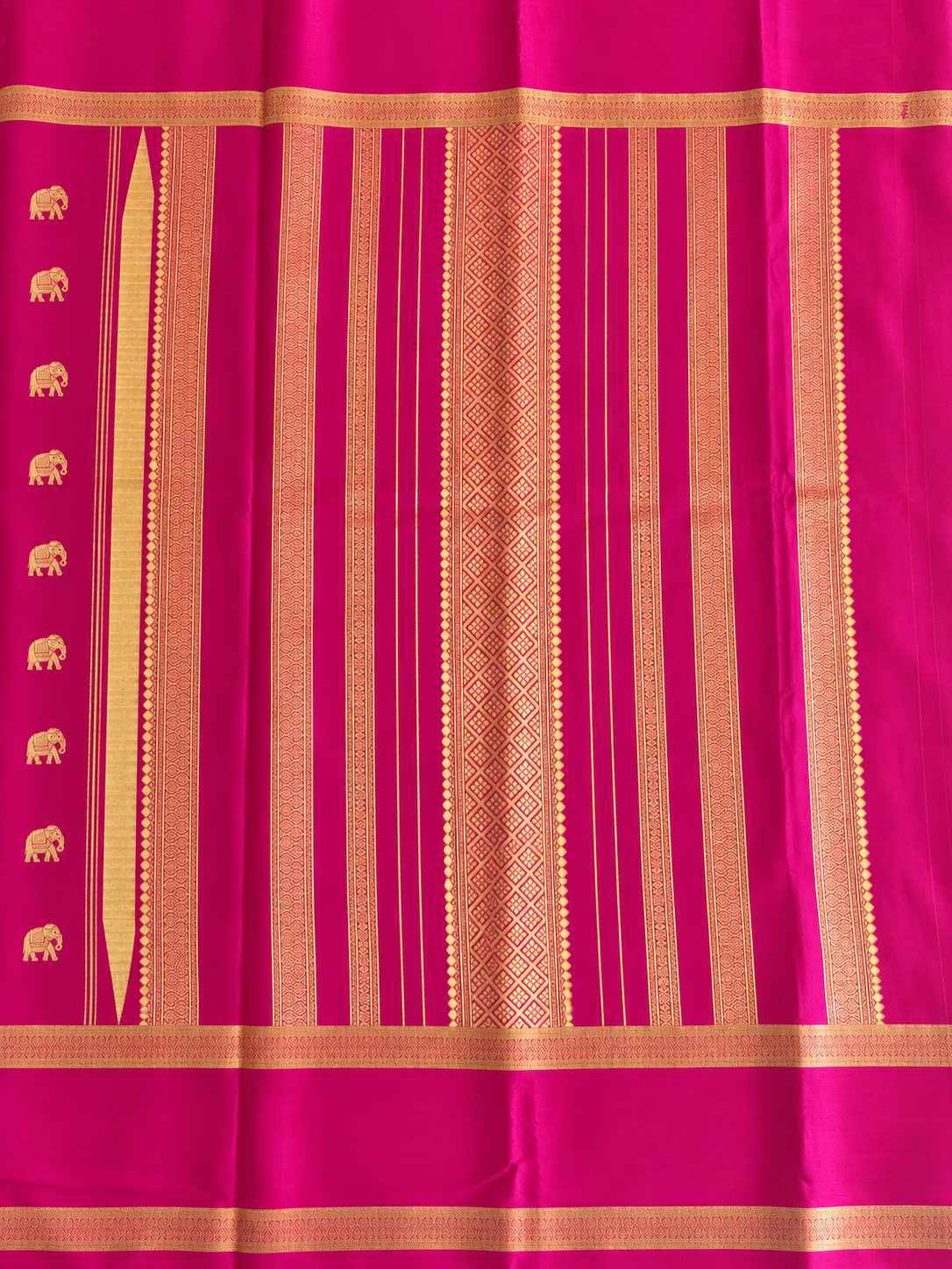 Rich magenta Mysore Crepe silk adorned throughout with Peacock, Gandaberunda, Topi and Elephant motifs in exquisite gold zari.