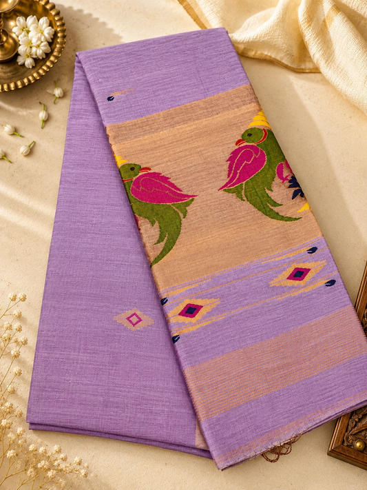 Elegant lavender Tissue Linen Jamdani saree with Paithani-style handwoven parrot motifs and delicate golden zari detailing.