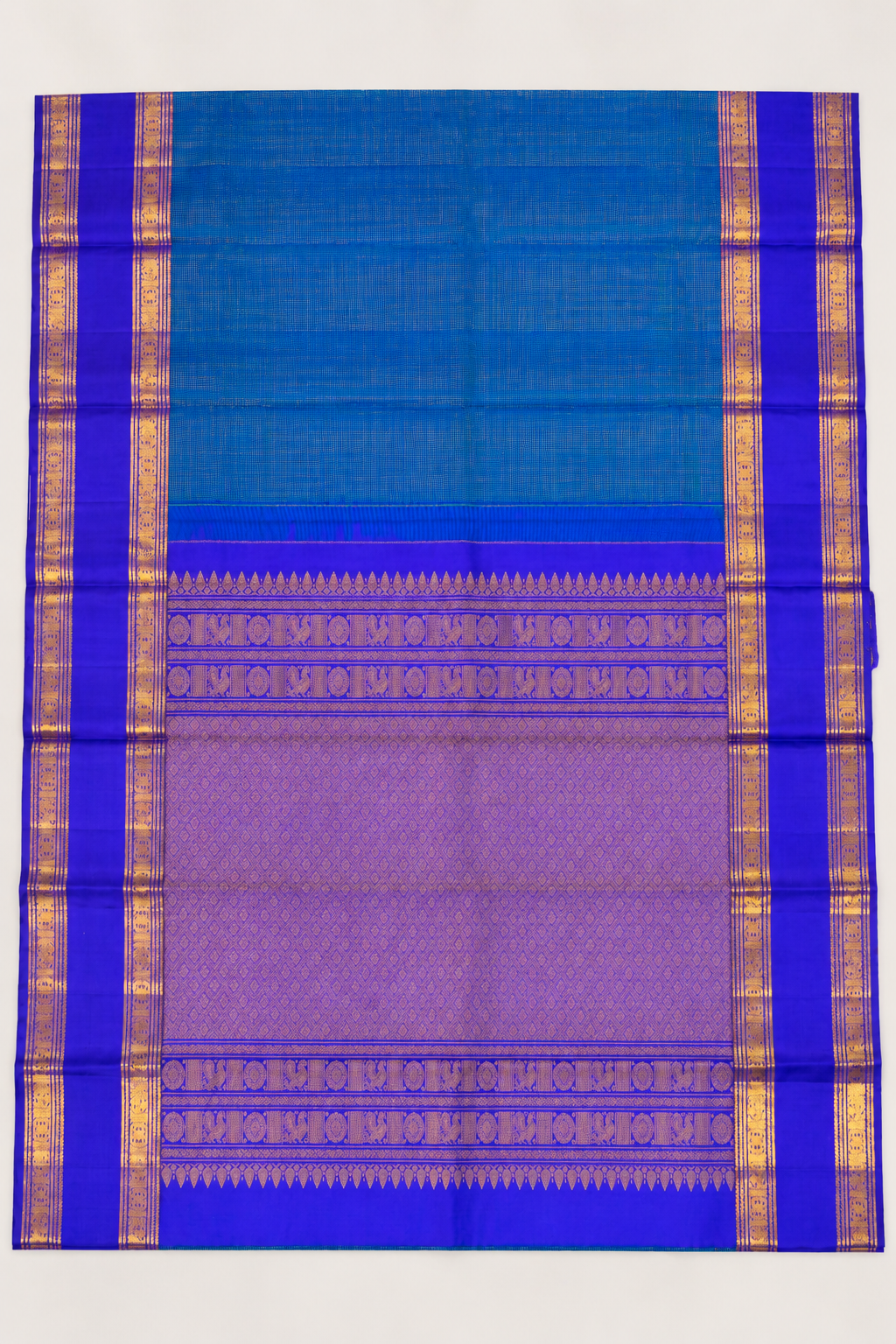 A luxurious royal violet Kanjivaram silk saree paired with a peacock teal pallu