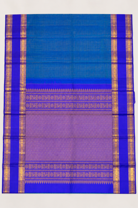 A luxurious royal violet Kanjivaram silk saree paired with a peacock teal pallu