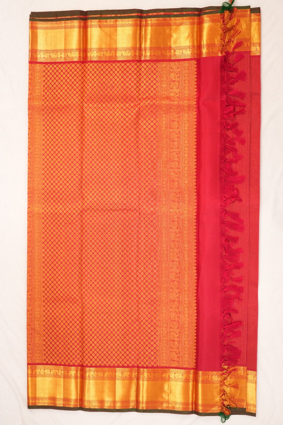 Rich deep crimson red Kanjivaram silk adorned with Gandaberunda motifs, peacocks, elephants and Rudraksha zari detailing.