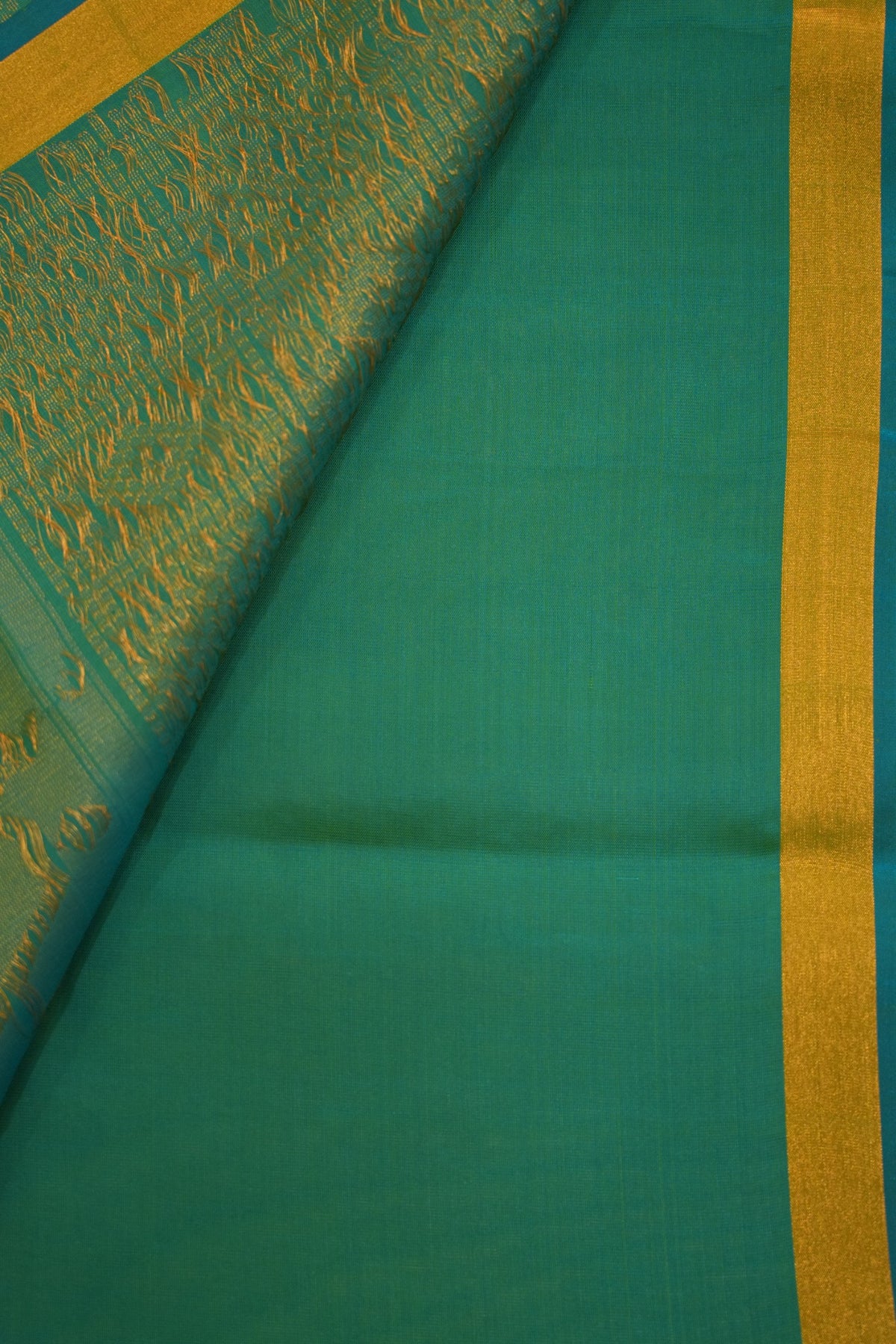 Vibrant lime green pure soft silk paired with teal blue, featuring elegant Paithani-inspired peacock motifs and traditional zari detailing.