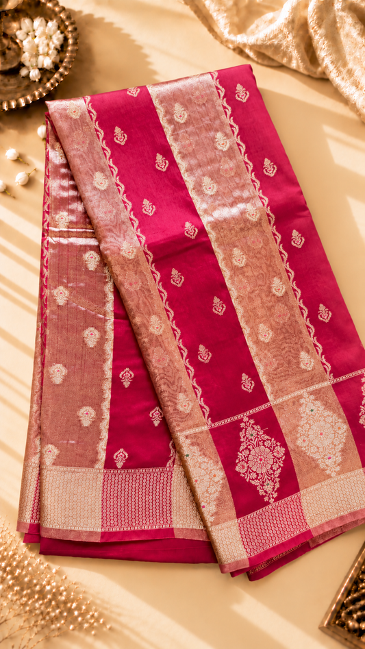 A luxurious Fuchsia Pink Banarasi viscose silk saree featuring intricate all-over Minakari weaving with delicate contrasting accents.