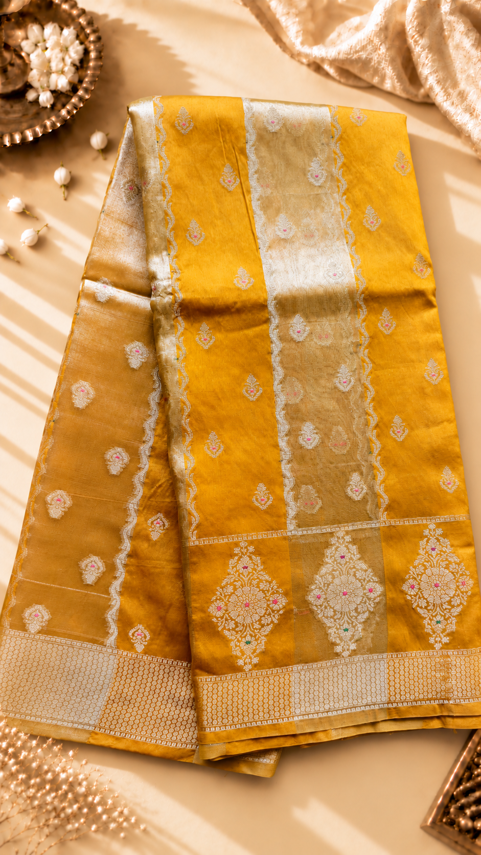 A luxurious Banarasi viscose silk saree in a rich mustard-gold shade, featuring intricate all-over Minakari weaving with delicate pink and green accent