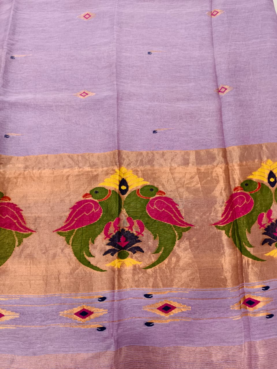 Elegant lavender Tissue Linen Jamdani saree with Paithani-style handwoven parrot motifs and delicate golden zari detailing.
