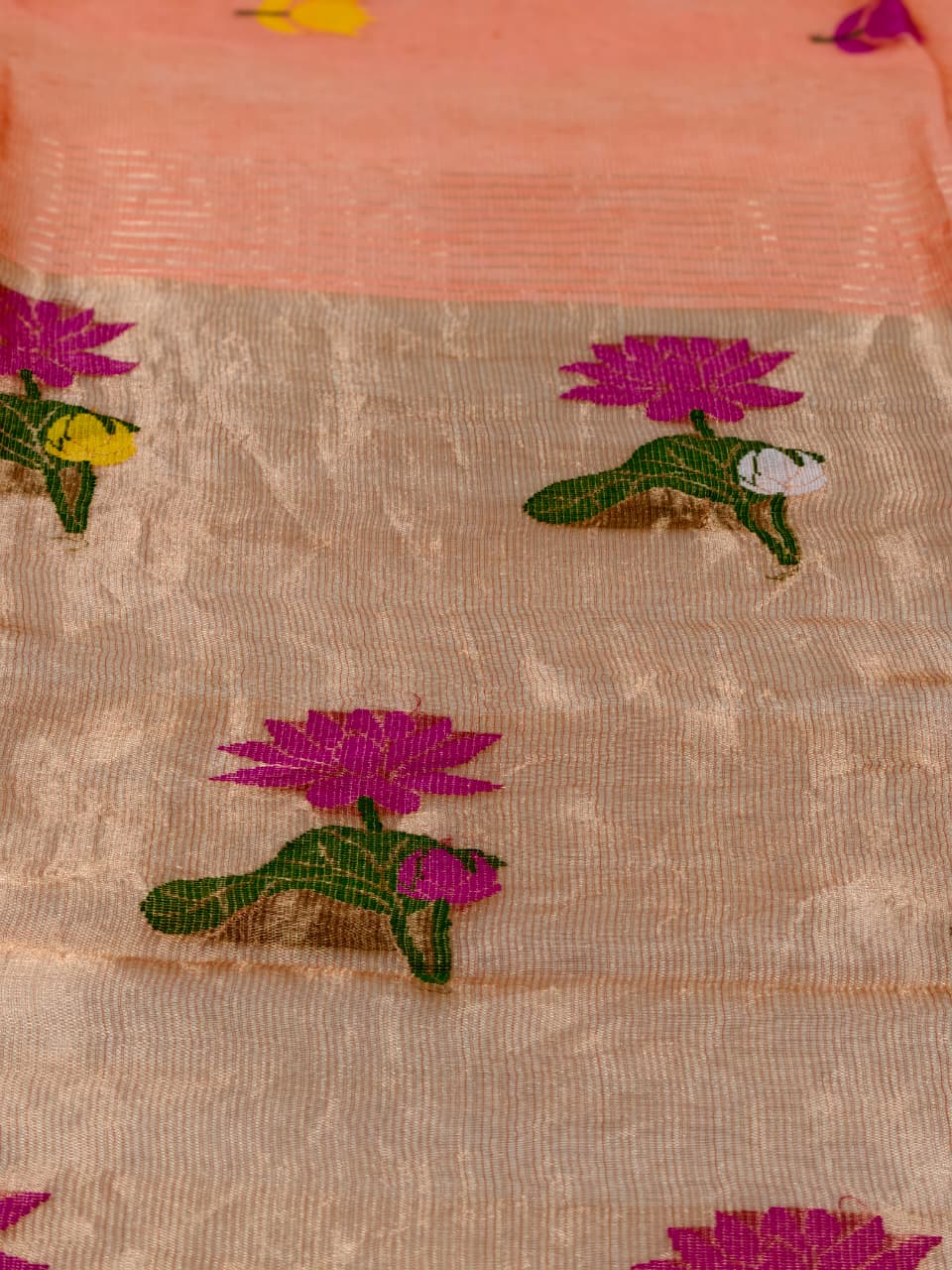 Handwoven Pure Tissue Linen Jamdani in warm burnt orange, adorned with vibrant floral motifs and delicate tissue zari detailing.