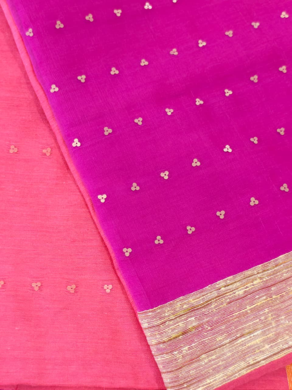 Handwoven Orange saree with a vibrant Pink Muslin pallu, featuring smooth woven coin motifs and a matching Pink contrast blouse.