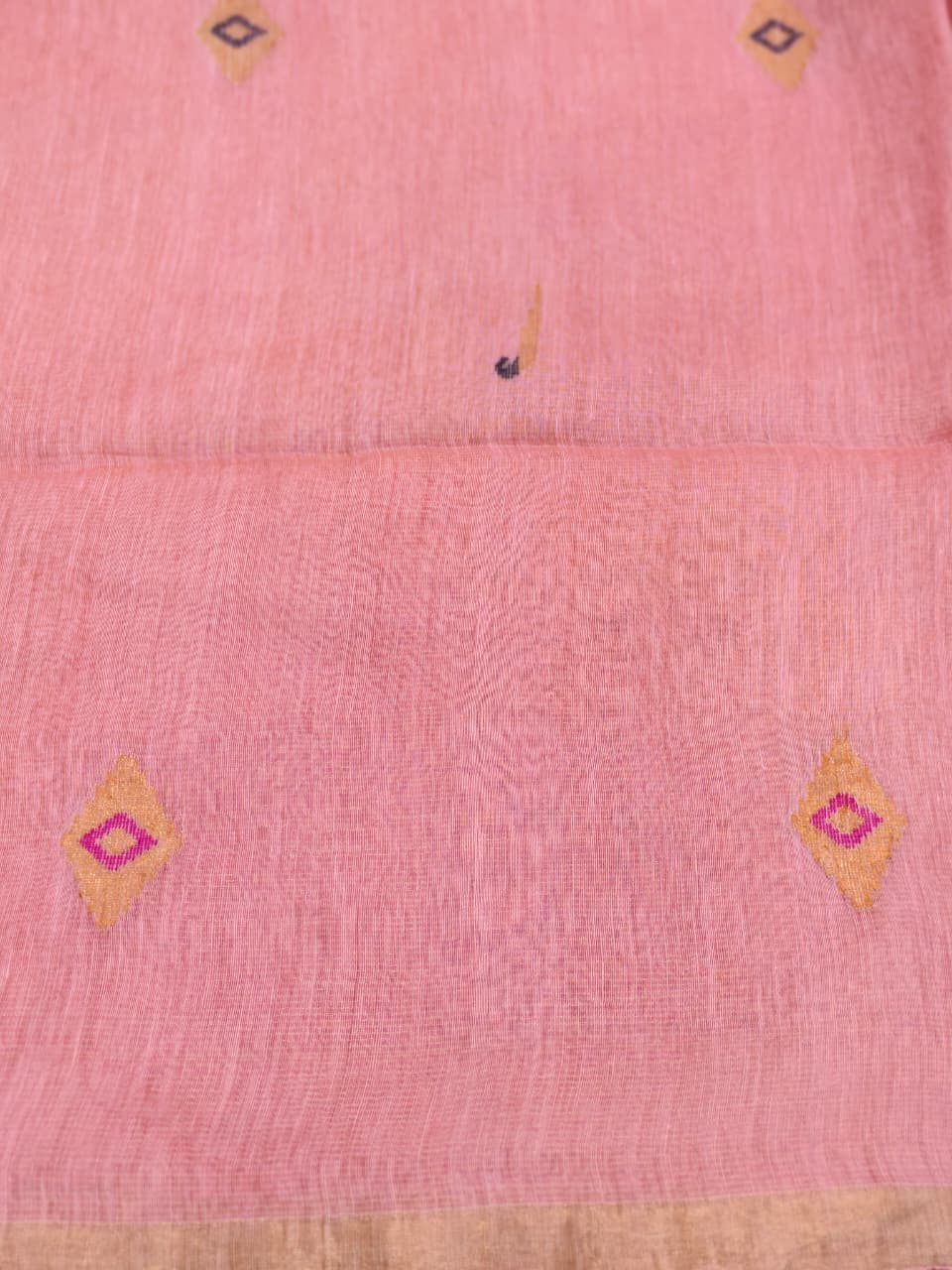 Elegant pastel pink Tissue Linen Jamdani saree with Paithani-style handwoven parrot motifs and delicate golden zari detailing.