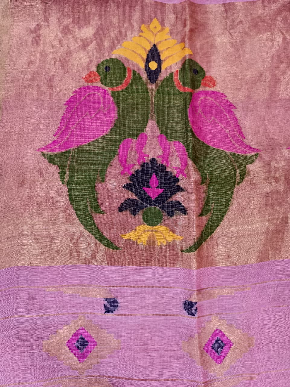 Elegant pastel pink Tissue Linen Jamdani saree with Paithani-style handwoven parrot motifs and delicate golden zari detailing.