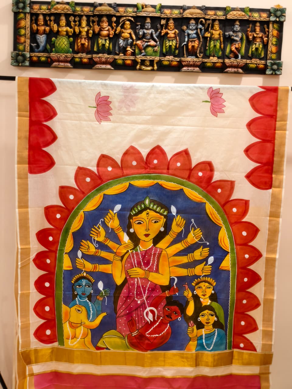 A beautiful hand-painted Durga Parivar design on a cotton saree with contrasting yellow blouse piece