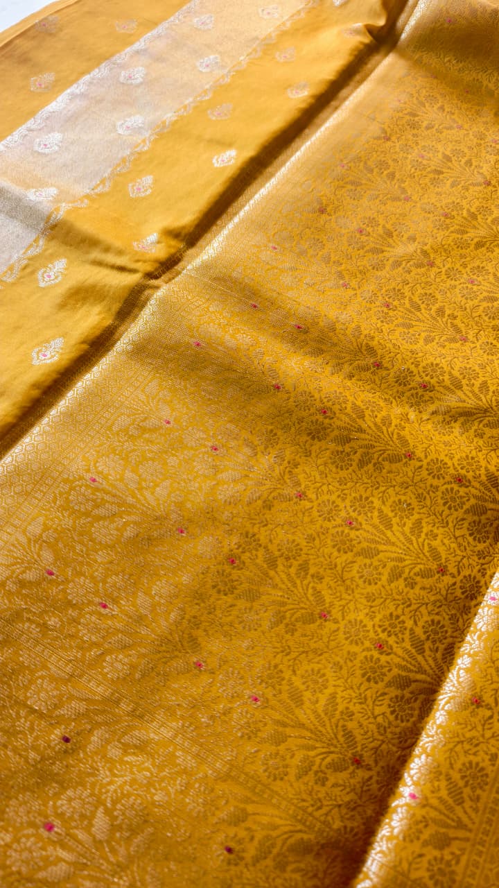 A luxurious Banarasi viscose silk saree in a rich mustard-gold shade, featuring intricate all-over Minakari weaving with delicate pink and green accent
