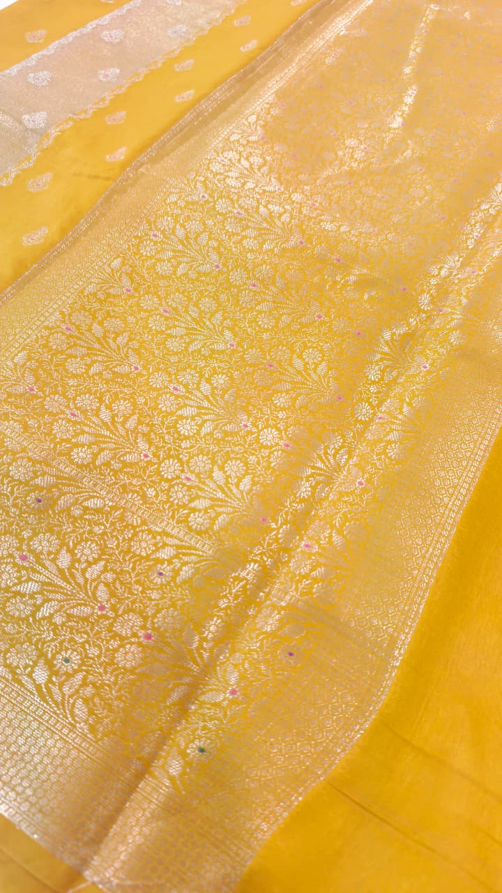A luxurious Banarasi viscose silk saree in a rich mustard-gold shade, featuring intricate all-over Minakari weaving with delicate pink and green accent