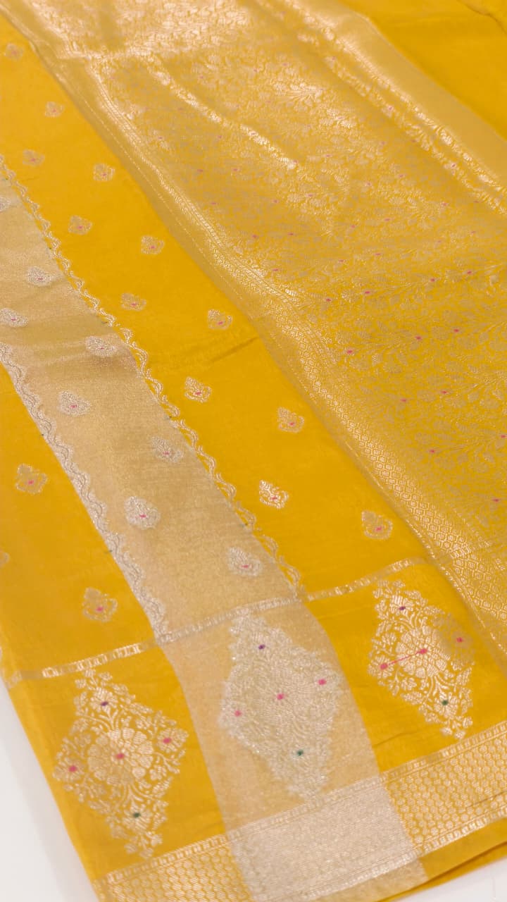A luxurious Banarasi viscose silk saree in a rich mustard-gold shade, featuring intricate all-over Minakari weaving with delicate pink and green accent