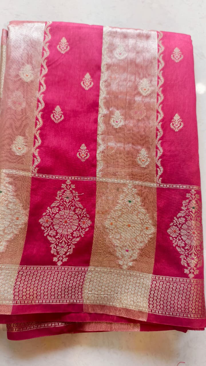 A luxurious Fuchsia Pink Banarasi viscose silk saree featuring intricate all-over Minakari weaving with delicate contrasting accents.