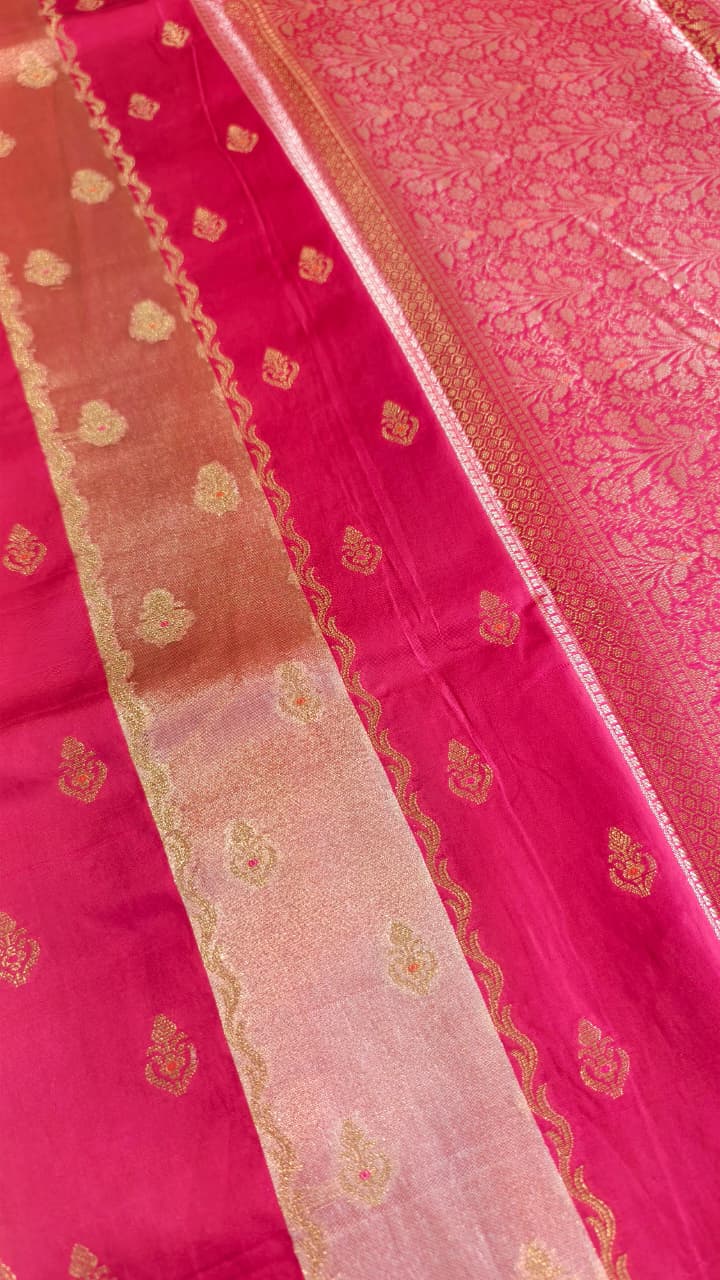A luxurious Fuchsia Pink Banarasi viscose silk saree featuring intricate all-over Minakari weaving with delicate contrasting accents.