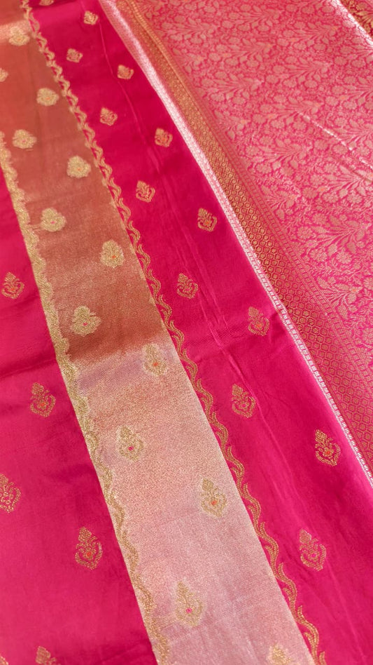 A luxurious Fuchsia Pink Banarasi viscose silk saree featuring intricate all-over Minakari weaving with delicate contrasting accents.