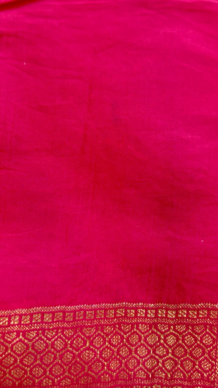 A luxurious Fuchsia Pink Banarasi viscose silk saree featuring intricate all-over Minakari weaving with delicate contrasting accents.