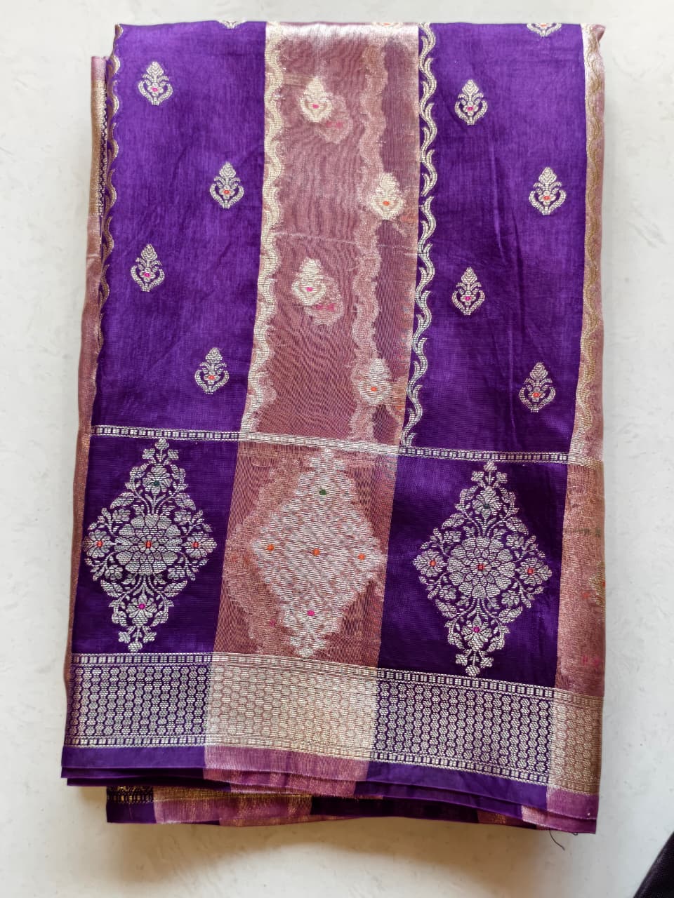 A luxurious Deep Purple Banarasi viscose silk saree featuring intricate all-over Minakari weaving with delicate contrasting accents.