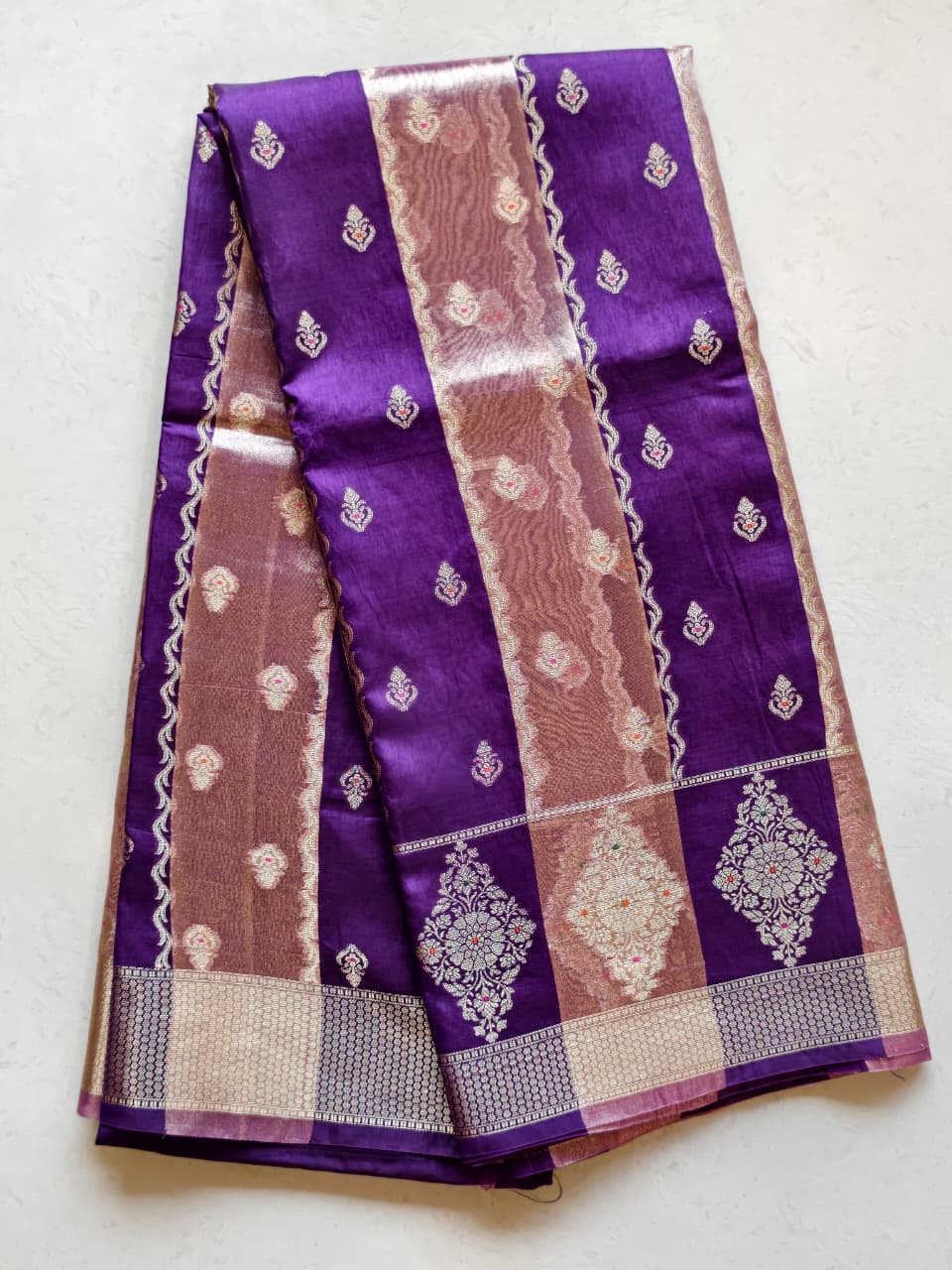 A luxurious Deep Purple Banarasi viscose silk saree featuring intricate all-over Minakari weaving with delicate contrasting accents.