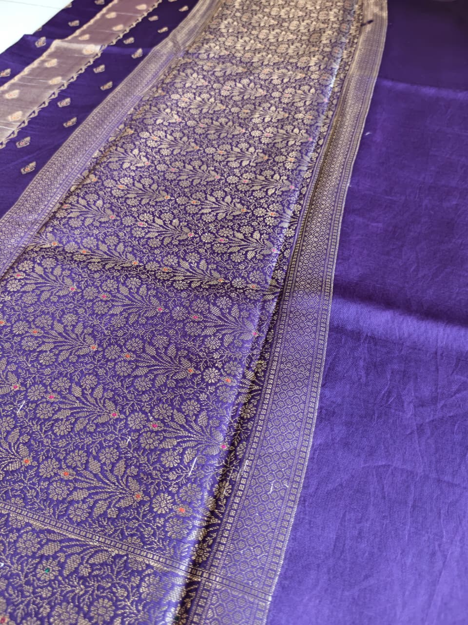 A luxurious Deep Purple Banarasi viscose silk saree featuring intricate all-over Minakari weaving with delicate contrasting accents.