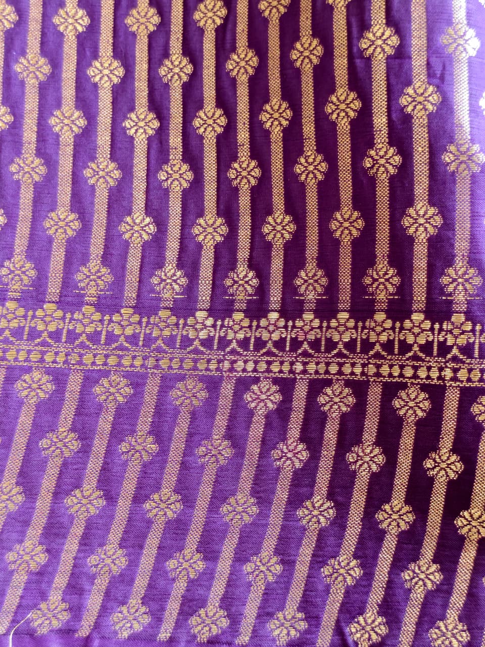 A regal Purple Banarasi viscose silk saree featuring intricate Minakari weaving, delicate traditional butis and an ornate floral pallu.