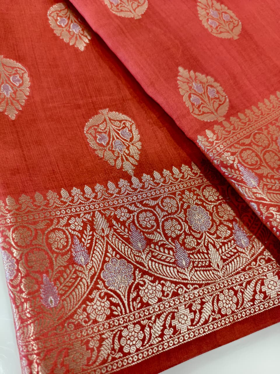 A rich Ruby Red Pure Silk Mark Certified Katan Chiniya Silk Banarasi Saree, featuring intricate traditional Banarasi weaving and elegant Chiniya-inspired motifs.