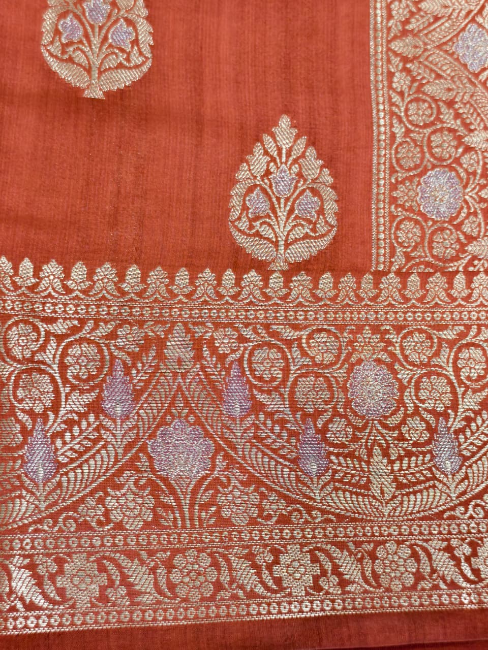 A rich Ruby Red Pure Silk Mark Certified Katan Chiniya Silk Banarasi Saree, featuring intricate traditional Banarasi weaving and elegant Chiniya-inspired motifs.