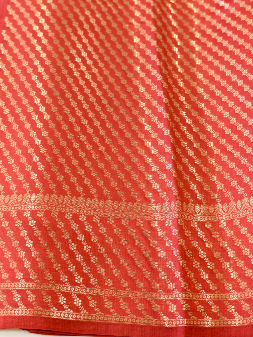 A rich Ruby Red Pure Silk Mark Certified Katan Chiniya Silk Banarasi Saree, featuring intricate traditional Banarasi weaving and elegant Chiniya-inspired motifs.