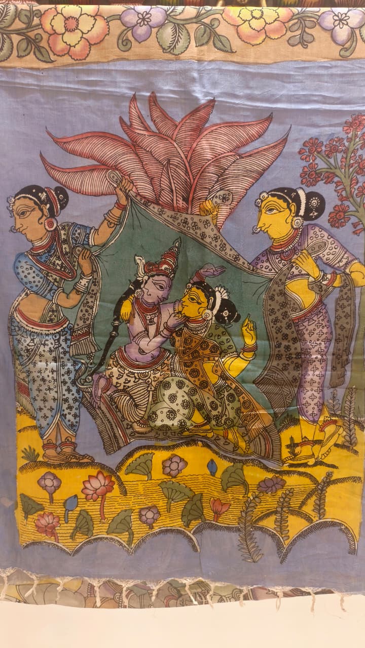 Hand-painted Kalamkari saree in Bangalore Silk featuring Rama & Sita on the body, Krishna & Radha on the pallu, floral borders, and a matching lavendar lotus-motif blouse piece