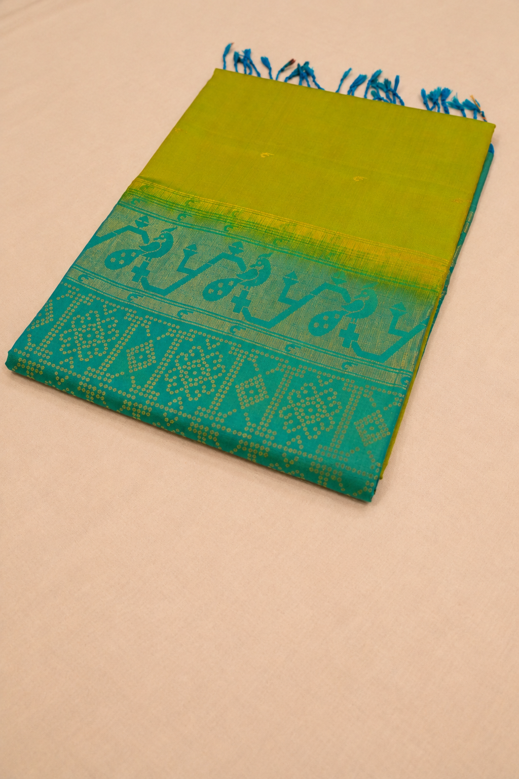Vibrant lime green pure soft silk paired with teal blue, featuring elegant Paithani-inspired peacock motifs and traditional zari detailing.